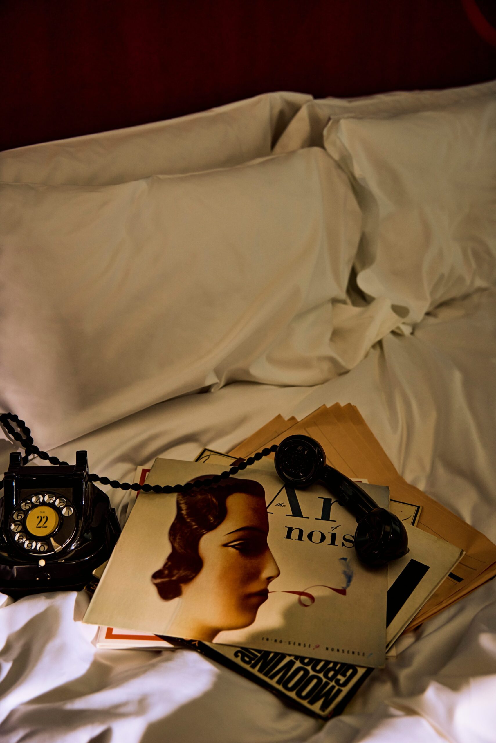 Vintage rotary phone displayed with retro magazine clippings, adding a nostalgic and stylish touch to The Twenty Two’s decor.