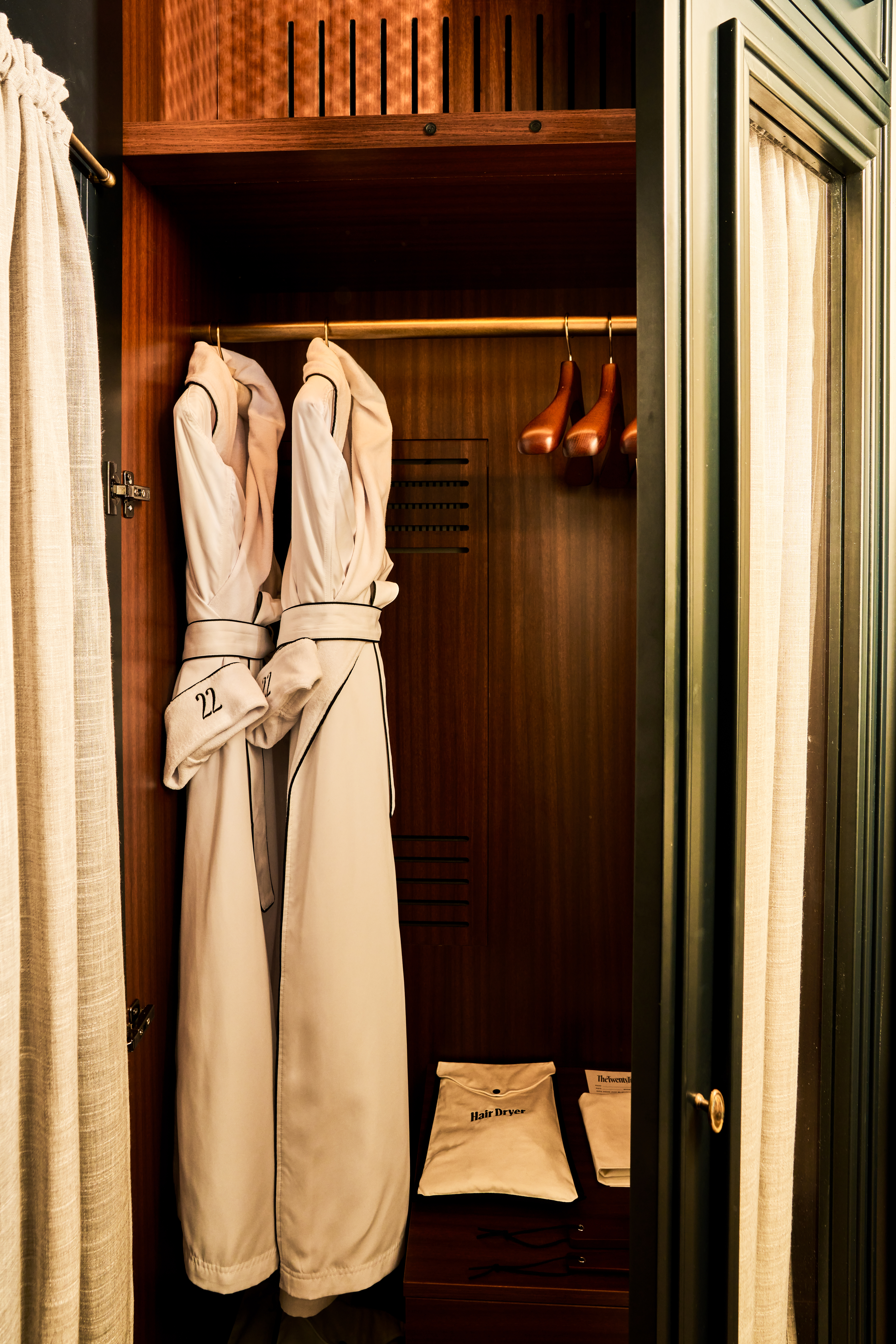 a closet with robes and shoes