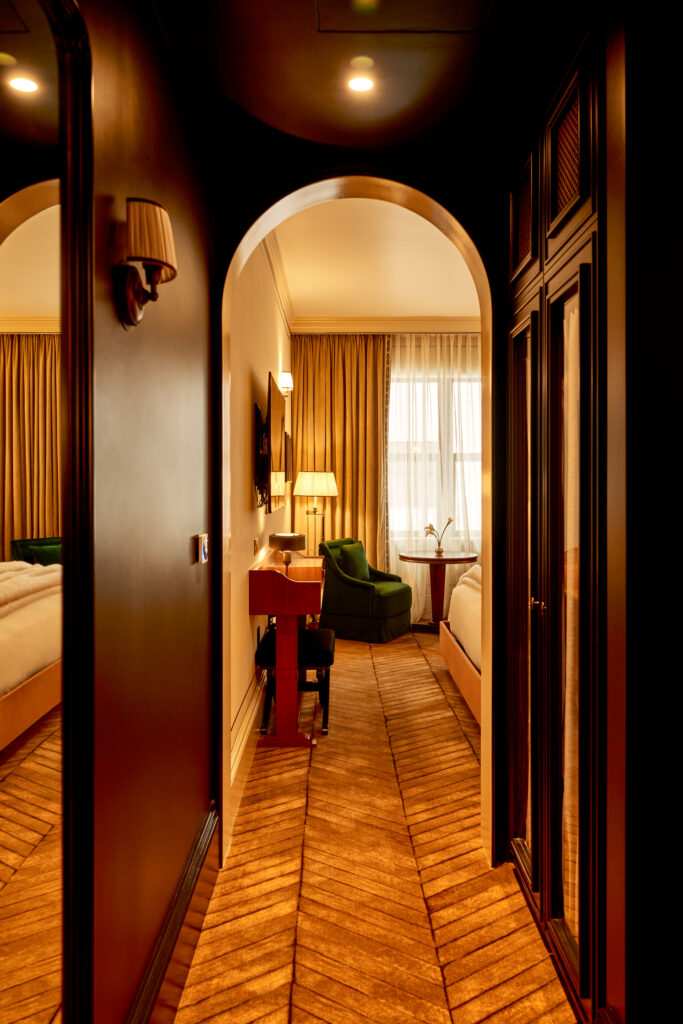 Hallway view leading into the Superior Room at The Twenty Two New York, showcasing its elegant design and luxurious ambiance.